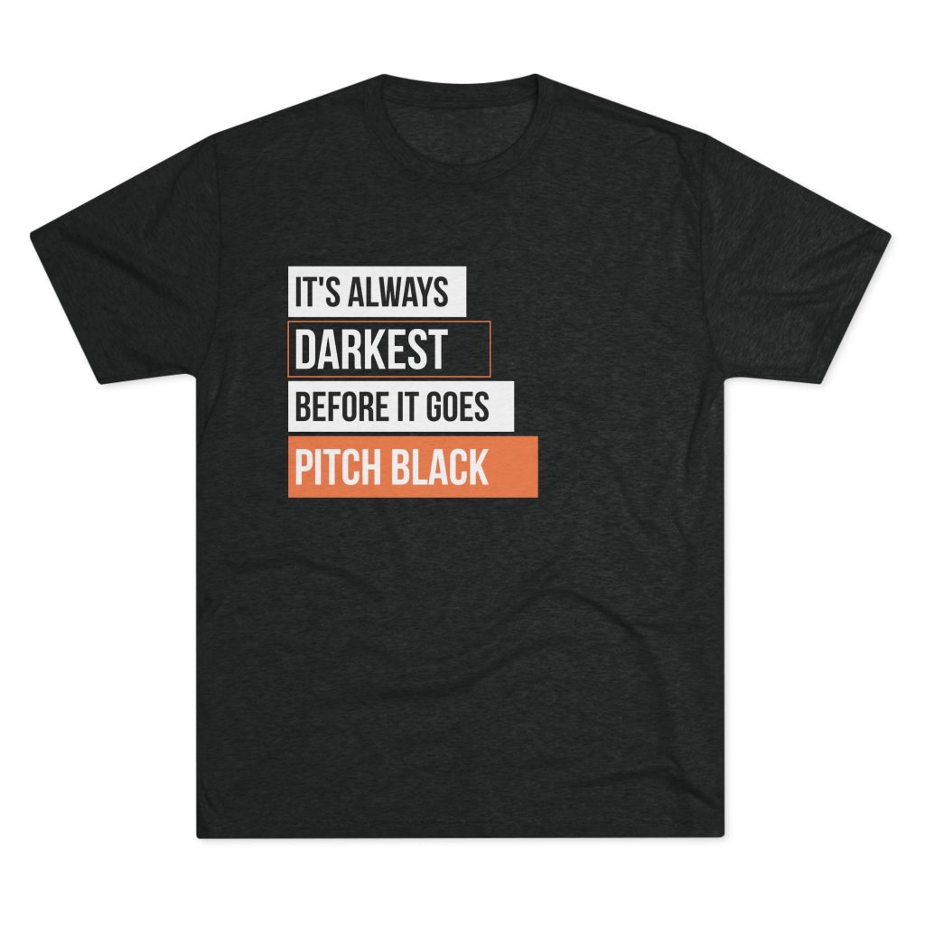 Men's T-shirt with the phrase 'It's Always Darkest Before It Goes Pitch Black', a dark-humor twist on the classic saying
